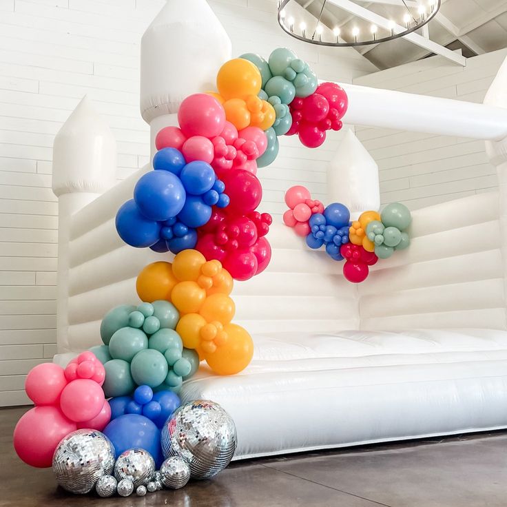 an inflatable balloon arch with balloons on it