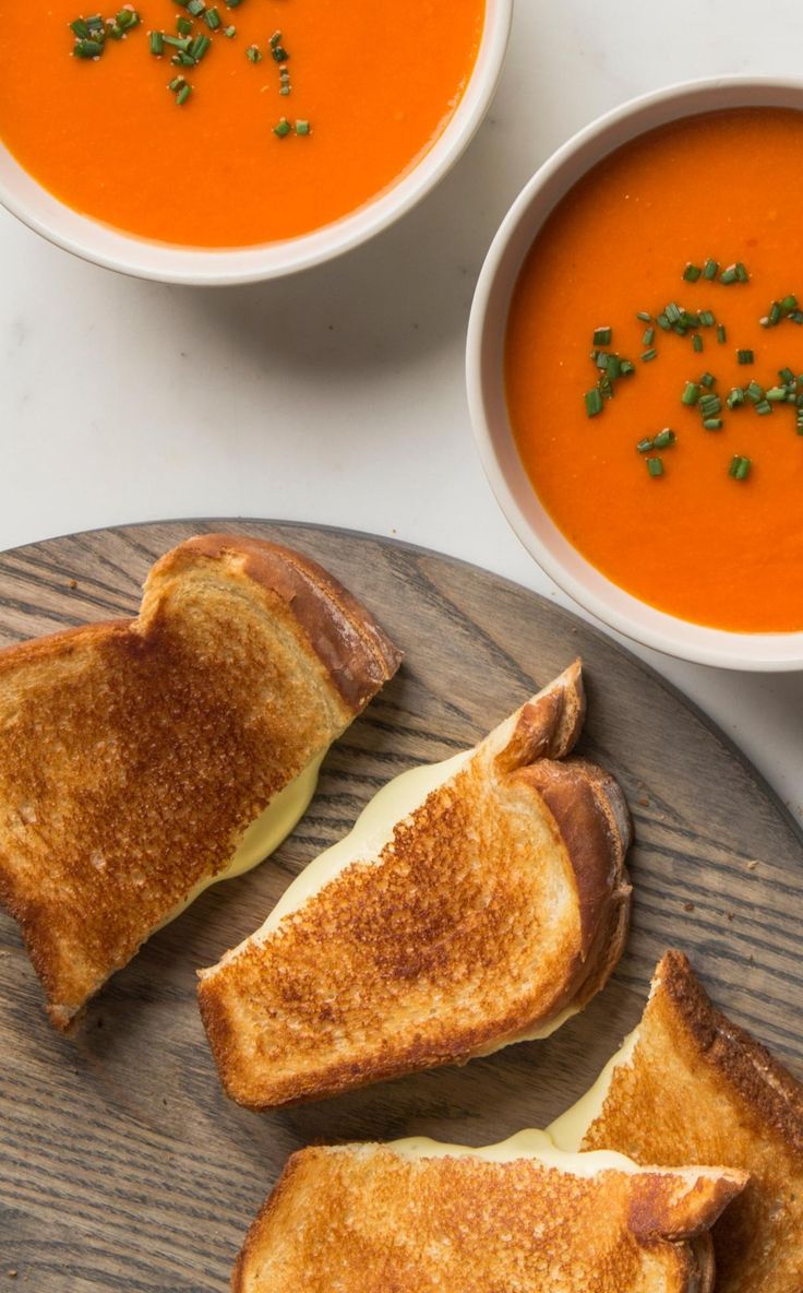 three bowls of soup and two pieces of toast on a plate