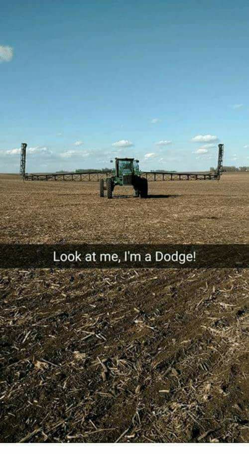 a tractor in a field with the words look at me, i'm a dodge