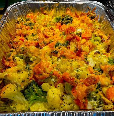 a casserole dish with broccoli and carrots in it