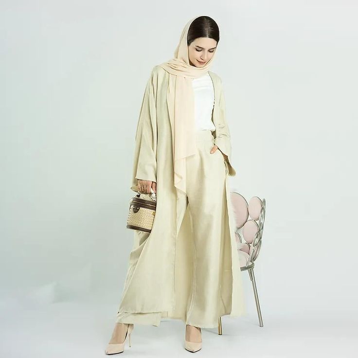 Introducing the 'Layinah' Linen-Like Natural Abaya by Jaela Modest Fashion – your go-to outfit for timeless elegance and modern versatility. Made from luxurious linen-like material, it ensures comfort throughout the season. The matching pants feature an elastic waist and wide legs, adding to the ease of wear and creating a gracefully flowing silhouette. Choose to wear it with or without the pants for a coordinated or contemporary look. Available in seven flattering shades to match your skin tone Eid Linen Long Sleeve Sets, Linen Long Sleeve Sets For Eid, Elegant Linen Sets For Eid, Abaya Kimono Dubai, Abaya Kimono, Open Abaya, Muslim Dress, Pant Sets, Luxury Linen