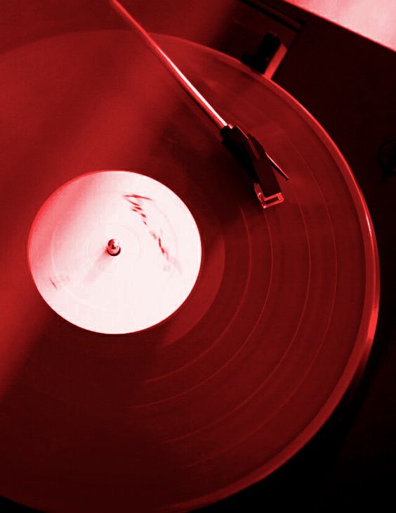 a record player's turntable with red light shining on it