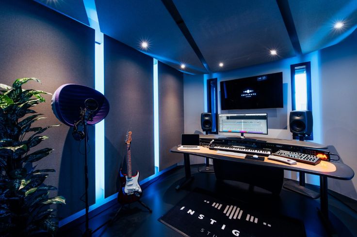 a room with a keyboard, guitar and other musical equipment