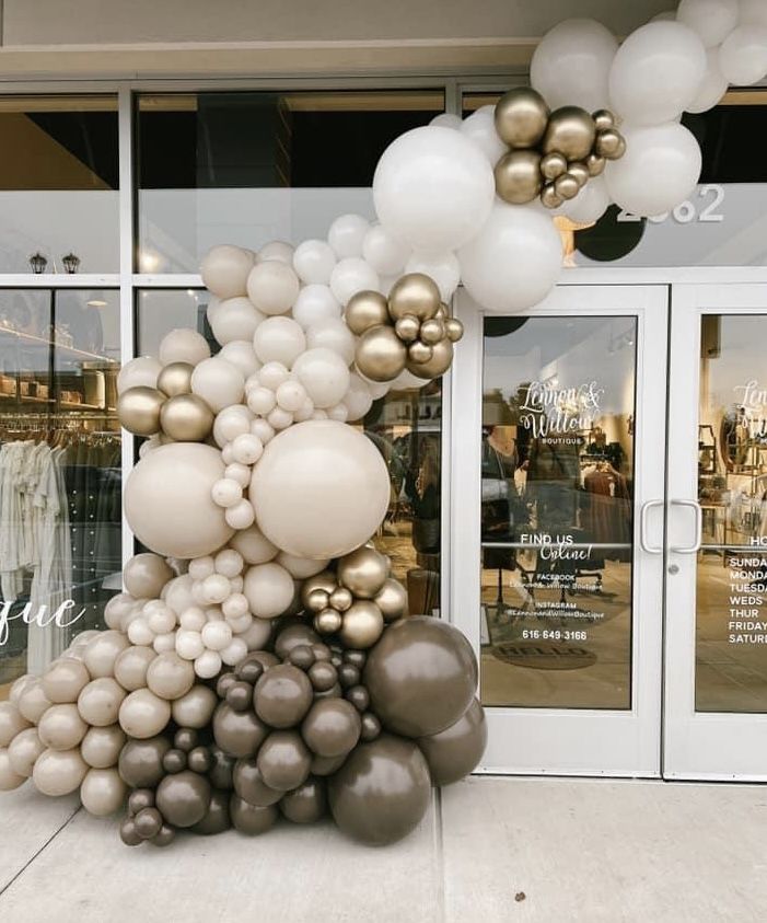 a bunch of balloons that are in front of a store