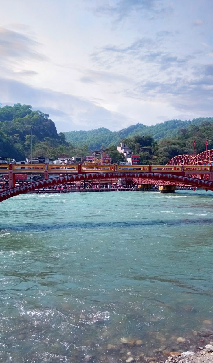 a red bridge spanning over a body of water