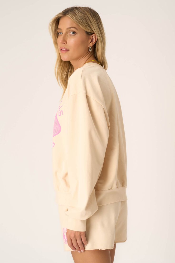 Meet you on the courts.The Pickleball Sweatshirt is inspired by the collegiate aesthetic we all can't get enough of. The playful pink graphic pops on our popular chalk colorway, creating the perfect combo of sporty and girly for spring. And, of course, you're guaranteed comfort with the baby French terry fabric. Pair with the Pickleball Short for the full outfit. 82% Cotton13% Polyester5% Spandex Care Instructions: Machine wash cold. Wash inside out with similar colors. Do not bleach. Lay flat t Logo Print Sweatshirt For Spring Loungewear, Athleisure Logo Print Sweatshirt For Spring, Relaxed Fit Logo Print Sweatshirt For Spring, Spring Athleisure Sweatshirt With Logo Print, Oversized Retro Sweatshirt, Trendy French Terry Tops For College, Relaxed Fit Sweatshirt For College In Spring, Trendy Cream Sweatshirt With Relaxed Fit, Cream Relaxed Fit Trendy Sweatshirt