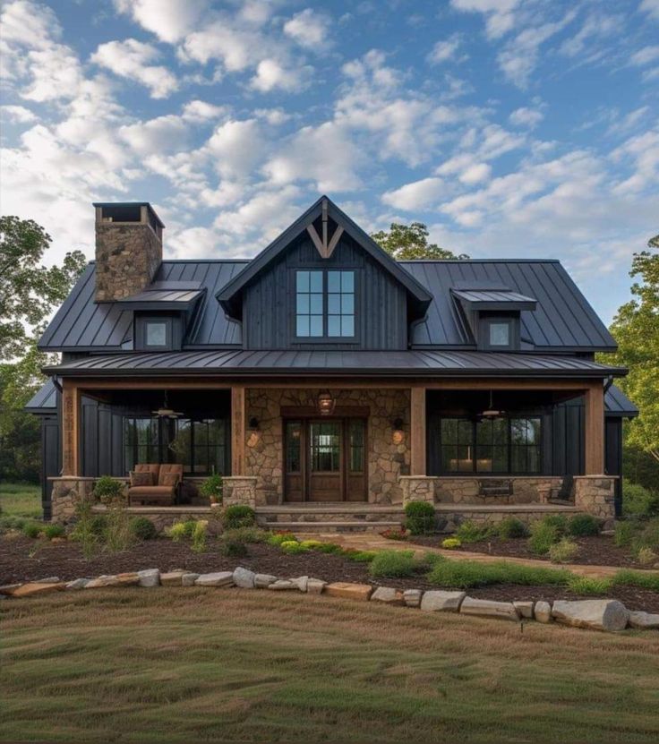 a large house with a metal roof and stone steps leading to the front porch area