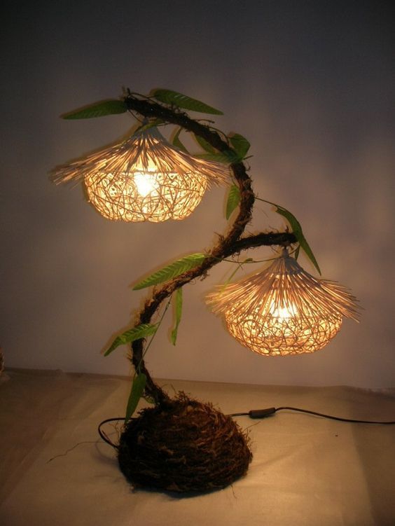 a lamp that is on top of a table next to a plant with lights in it