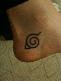 a person with a tattoo on their foot that has a spiral design on the bottom