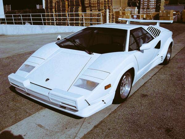 a white sports car is parked on the street