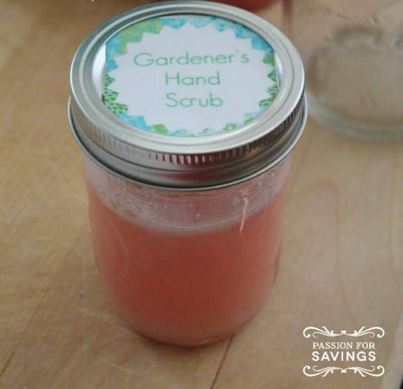 a mason jar filled with pink liquid sitting on top of a wooden table next to two jars