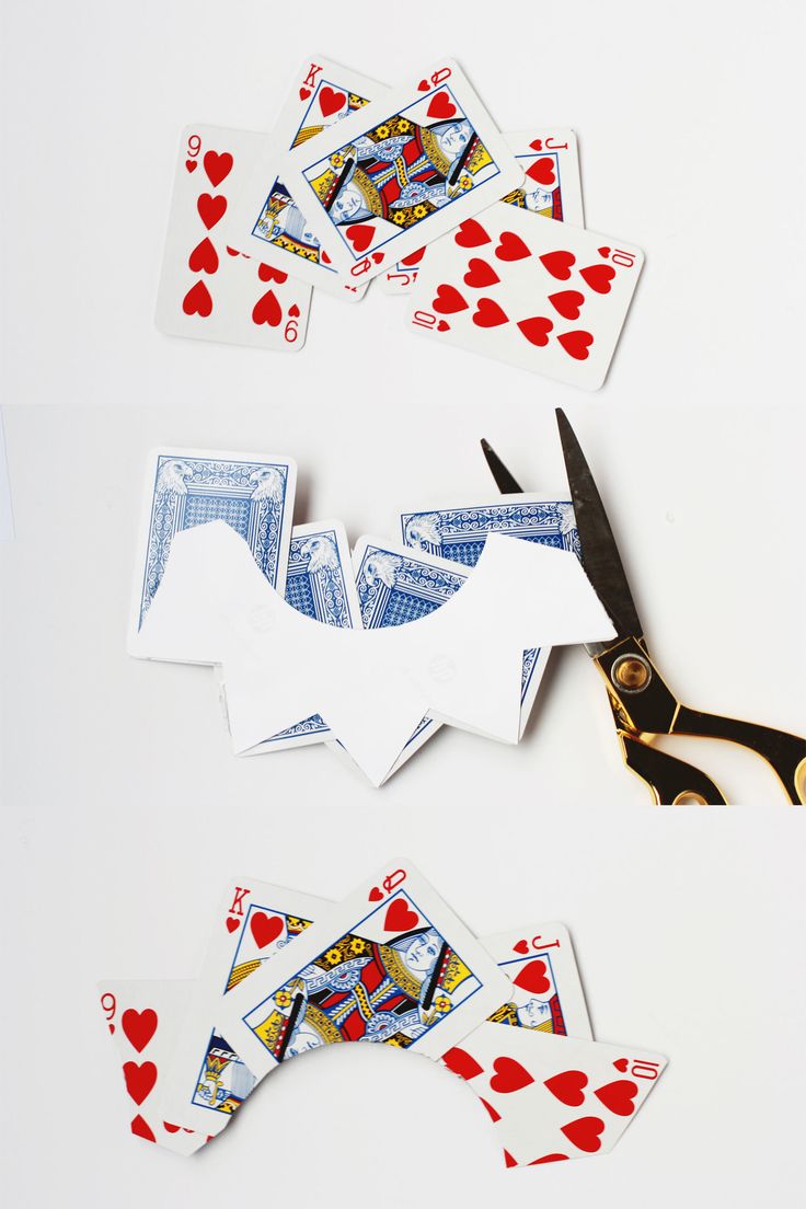 scissors and playing cards cut out to look like they have been made into an origami bird