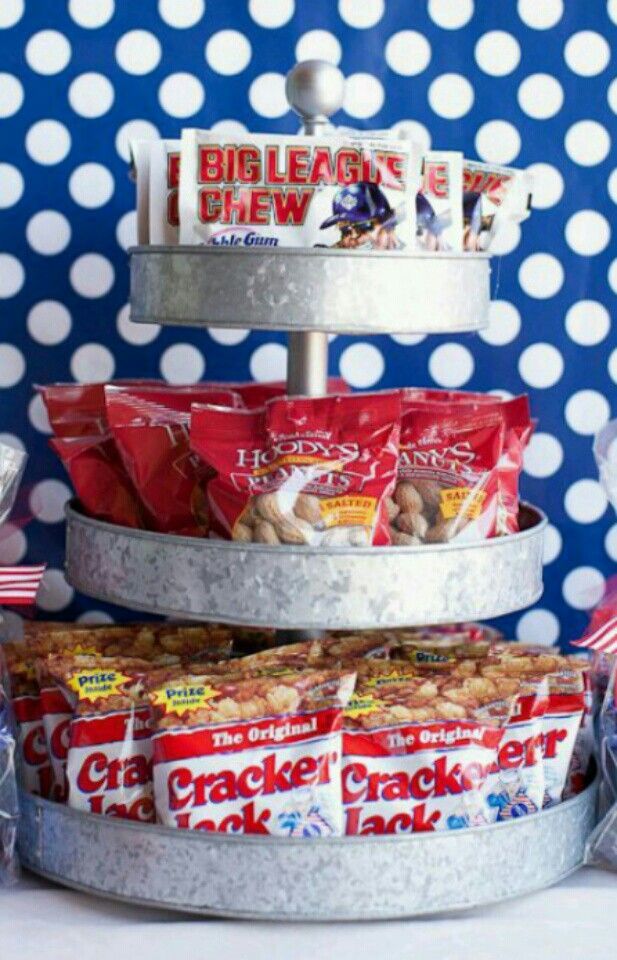 three tiered trays filled with snacks on top of each other in front of a polka dot wall