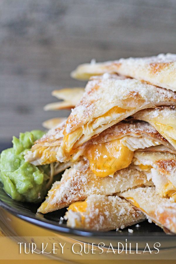 a stack of quesadillas on a plate with guacamole