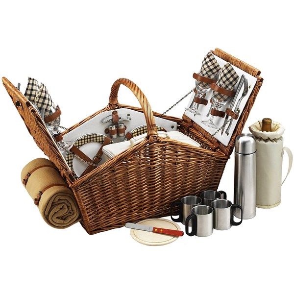 a wicker picnic basket filled with silverware and wine glasses next to two mugs