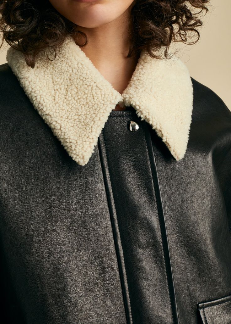 Description With pieces such as this buttery leather jacket,â the Pre-Fall collectionâ proposes a wardrobe that is both singular and universal. The shearling collared, zip- and snap-front silhouette combines the clean lines of a moto jacket with the softened volumes of a classic bomber. Finishing touches include a back yoke, patch pockets, and knit insets at the hem and cuffs.â Details Material:â Textured lamb (100% lambskin), lined in 100% cupro Care: Specialist clean Fit: True to size. Recomme Fall Shearling Biker Jacket With Padded Collar, Chic Shearling Leather Jacket For Work, Collared Biker Jacket For Winter Workwear, Collared Biker Jacket For Winter, Black Shearling Biker Jacket With Padded Collar, Black Leather Jacket With Ribbed Collar For Winter, Winter Leather Jacket With Padded Lapel Collar, Black Winter Outerwear With Collar, Black Leather Jacket With Padded Collar