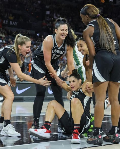 the women's basketball team huddle together on the court