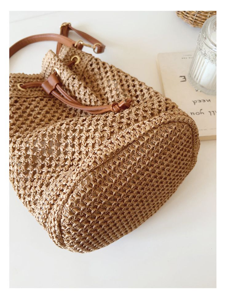 a straw bag sitting on top of a white table