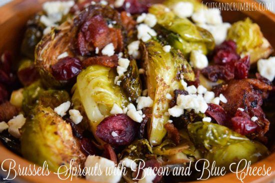 brussel sprouts with bacon and blue cheese in an orange bowl on a table