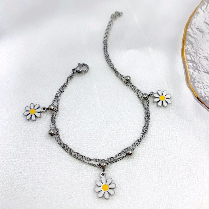 Embrace the girly charm of our Daisy Charms Bracelet and let it be your go-to accessory for every occasion. Whether worn alone or layered with other bracelets, it's sure to become a cherished favorite in your jewelry collection. Available in silver and gold. Daisy Charm, Charms Bracelet, Silver And Gold, Ring Necklace, Silver Bracelets, Free Gifts, Ring Earrings, Necklaces Bracelets, Silver Gold