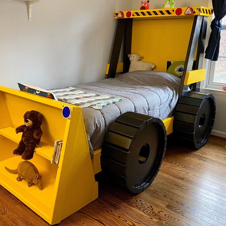 a child's bed made to look like a dump truck with wheels on it