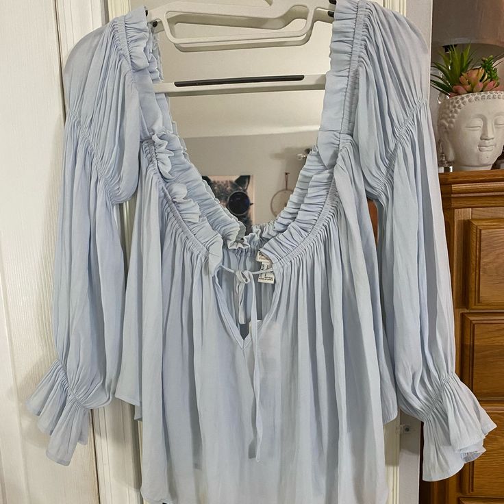 Pastel Blue Off The Shoulder Long Sleeve Blouse Light Blue Blouse For Spring Vacation, Light Blue Blouse For Vacation In Spring, Light Blue Long Sleeve Blouse For Brunch, Spring Light Blue Flowy Top, Flowy Blue Blouse For Day Out, Blue Blouse For Spring Brunch, Light Blue Blouse For Fall Daywear, Light Blue Flowy Blouse For Spring, Blue Flowy Peasant Top For Spring