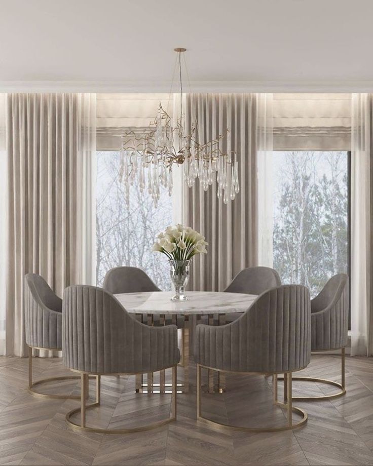 a dining room table with chairs and a chandelier