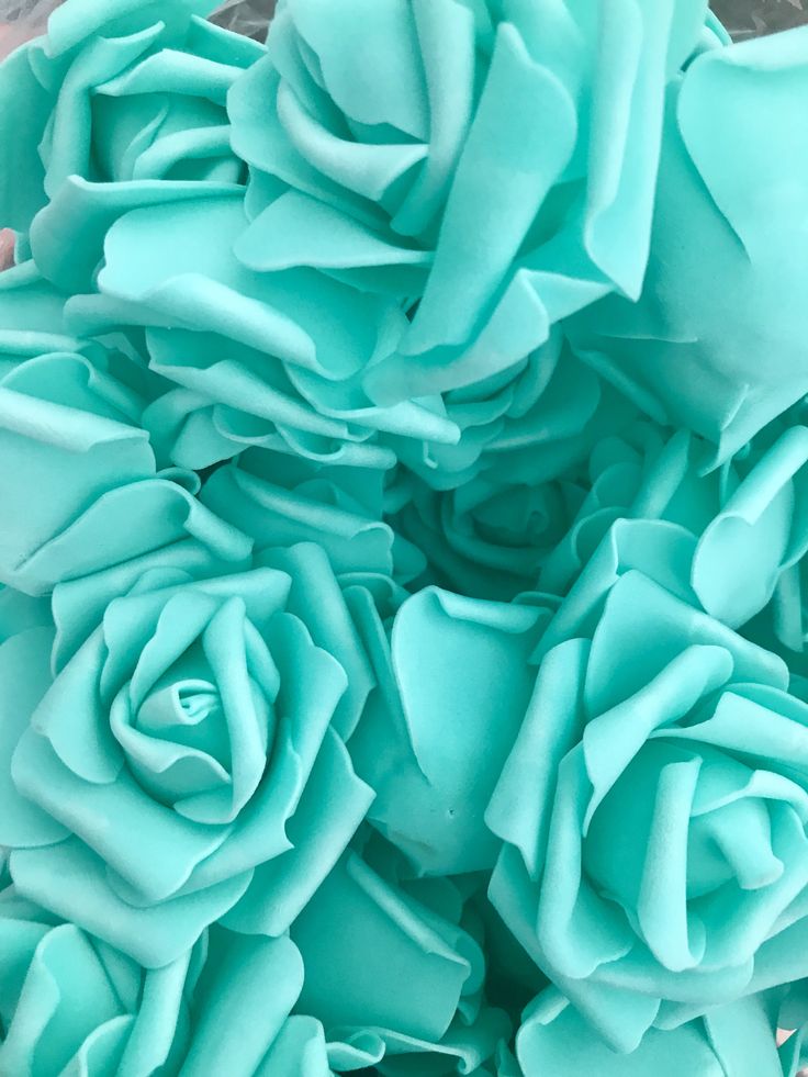 a bunch of blue flowers sitting on top of a table