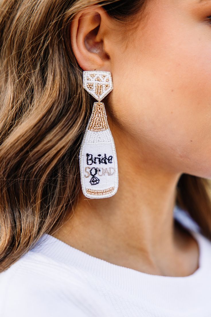 You are the bride and that calls for bubbles! These earrings are so perfect for any bride to be! They are so cute and we love how light they are as well! These fun earrings are sure to complete any bridal shower or bachelorette party look! White Glamorous Chandelier Earrings For Party, White Drop Bridal Earrings For Parties, White Glamorous Party Earrings, Glamorous White Party Earrings, White Dangle Bridal Earrings For Party, Bridal Beaded Dangle Earrings For Wedding, Glamorous White Earrings For Party, Beaded Dangle Bridal Earrings For Wedding, White Dangle Bridal Earrings