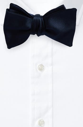 The label's impeccable attention to detail is displayed in this classically handsome bow tie hand-stitched from pure silk by Italian artisans. 100% silk Dry clean Made in Italy Designer Ties For Black Tie Events, Classic Pre-tied Decorative Bow, Silk Tuxedo For Business, Classic Black Tie Event Bow Tie, Classic Pre-tied Satin Bow Tie, Classic Black Tie With Decorative Bow, Classic Bow Ties For Black-tie Events, Classic Satin Suit And Tie Accessories, Classic Silk Ties For Wedding