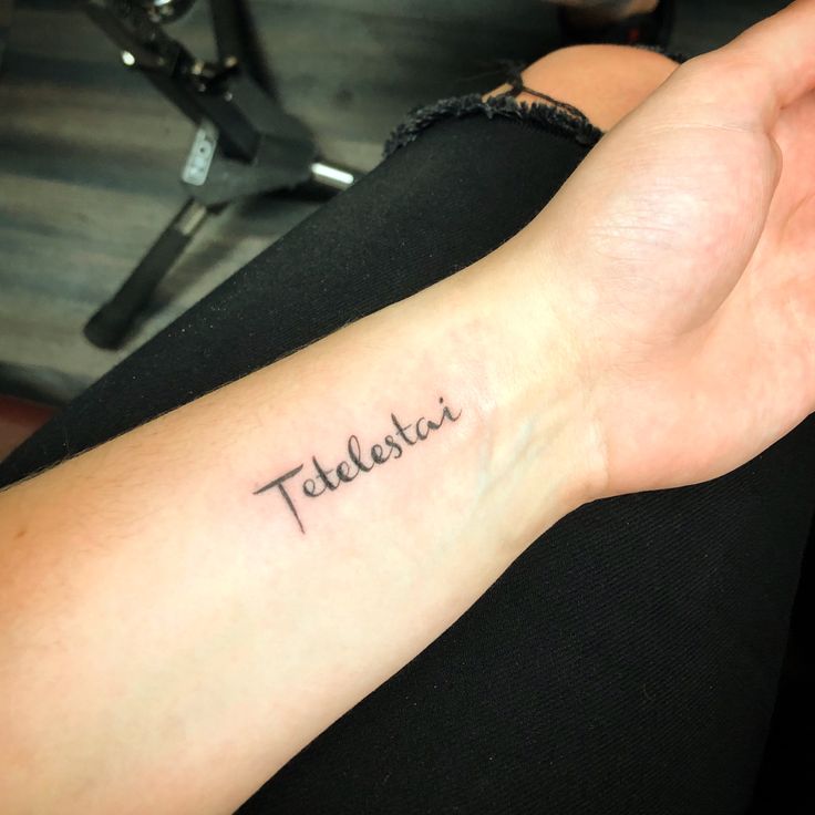 a woman's arm with a tattoo that reads talbestati on it