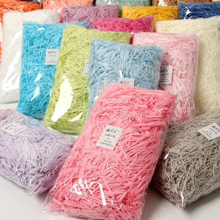 various colors of yarn wrapped in cellophane and sitting on top of each other