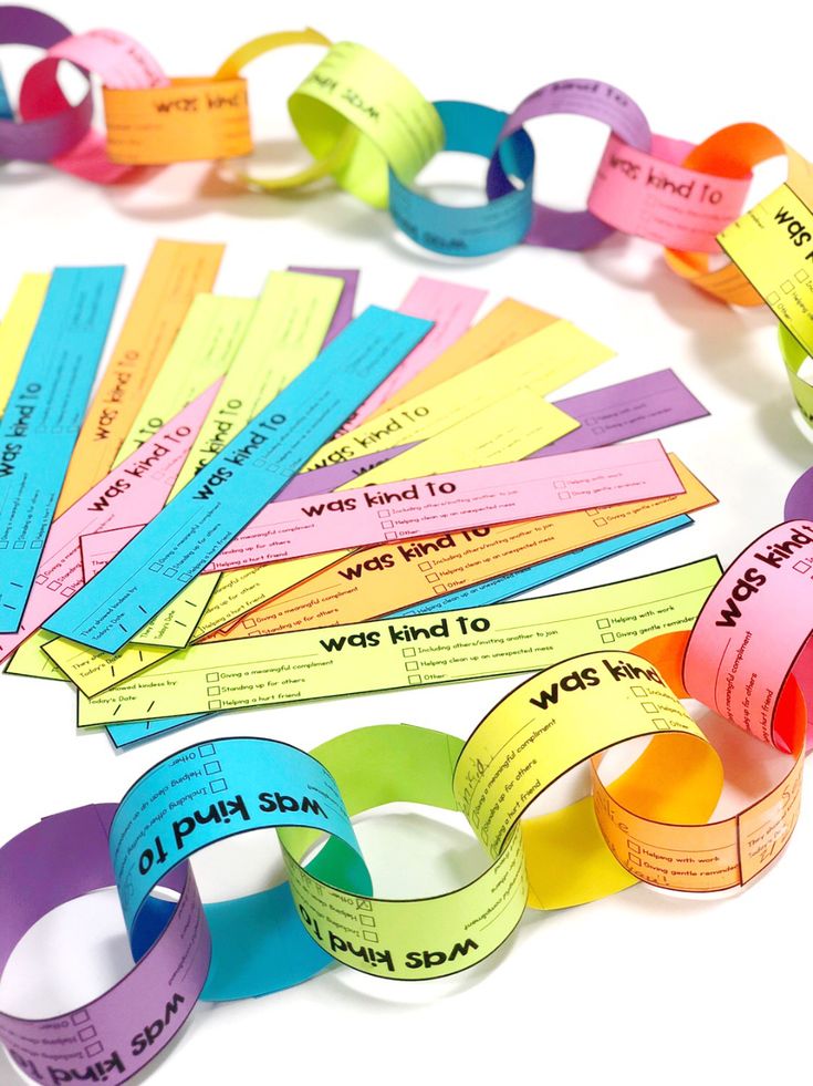 colorful paper bracelets with words on them and some sort of word in the middle