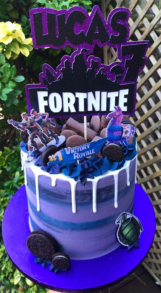 a birthday cake decorated to look like the movie fortnite is on top of a purple plate