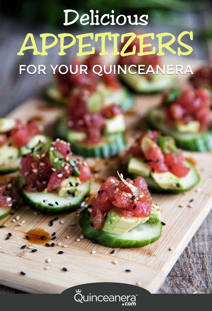 cucumbers with tomatoes and black sesame seeds on a cutting board