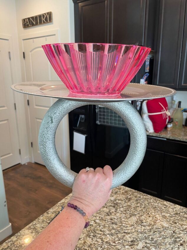 a person is holding a glass plate on top of a counter