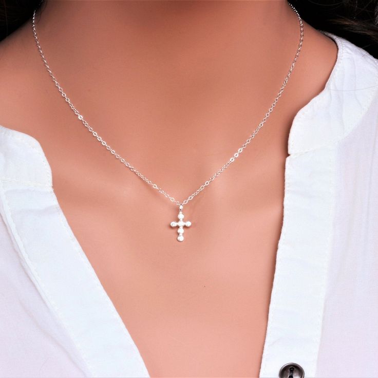 "Sterling Silver Cross Necklace - Religious Jewelry - Tiny Sterling silver CZ Cross Necklace - Layering Necklace Dainty Cross Necklace - Gift for Her ★★The necklace makes of .... -Sterling Silver 9.4x17.5mm Small CZ Cross Pendant, 3.2mm Closed Ring Sterling silver cable chain with spring claw . -Total length will be 16\" 17\" 18\" or 19\" depend on customer request. -Come up with beautiful ribbon gift box -One set of care instruction package that enhance your present ... All quantities are avail Dainty Cross Jewelry For Mother's Day, Sterling Silver Cross Necklaces For Mother's Day, Silver Cross Jewelry For Mother's Day, Sterling Silver Clavicle Chain Cross Necklace, Spiritual Cross Necklace With Silver Chain For Gift, Silver Cross Pendant Jewelry For Mother's Day, Silver Cross Pendant Necklace For Mother's Day, Silver Charm Necklace For Her, Mother's Day Sterling Silver Cross Pendant Jewelry