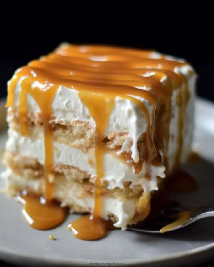 a piece of cake with caramel drizzled on top and frosting