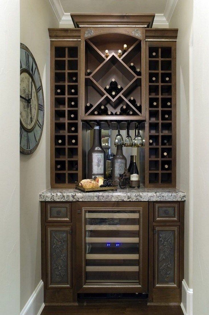 a wine rack with several bottles in it and a clock on the wall behind it