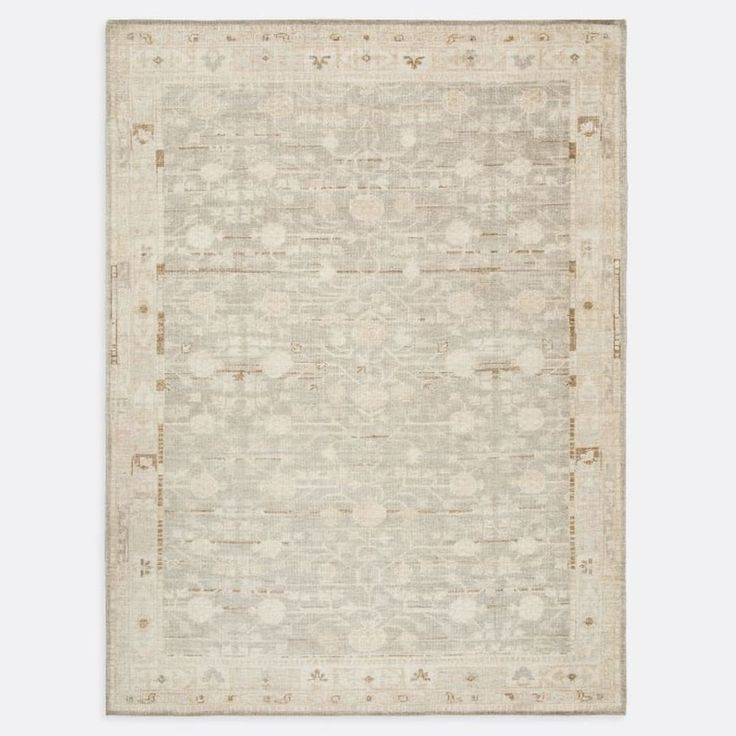 a beige rug with an intricate design on the top and bottom, in front of a white background