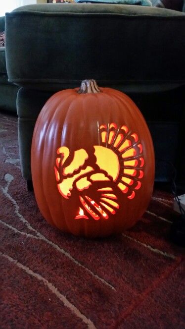 a carved pumpkin with a turkey on it