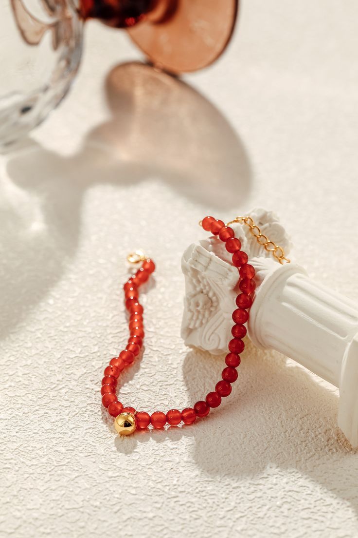 The "Lucky" Red Agate Gemstone Bracelet is a symbol of hope and fortune, crafted to bring a touch of optimism to your everyday. Delicate yet powerful, each natural red agate stone (3-4mm) is a reminder of resilience and inner strength. Paired with 18k Gold Vermeil over sterling silver, this piece exudes warmth and grace, carrying a story of beauty and good luck. Materials: 18k Gold Vermeil over Sterling Silver, adorned with natural red agate gemstones. Dimensions: Chain length of 6.7" with a 1.2 Red Carnelian Beaded Bracelet With Round Beads, Red Carnelian Beaded Bracelets With Round Beads, Red Carnelian Beaded Bracelets With Gemstone Beads, Red Carnelian Round Beads Bracelet, Red Carnelian Bracelets With Polished Beads, Red Carnelian Beaded Bracelets, Elegant Red Agate Beaded Bracelets, Elegant Red Carnelian Beaded Bracelets, Red Agate Jewelry With 108 Beads