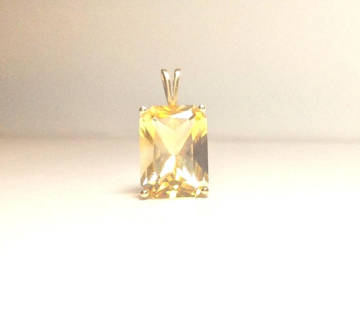 Exquisite golden yellow topaz emerald cut prong set in 14k yellow gold pendant. Not often do you find this carat size in a natural golden yellow topaz. Absolutly gorgeous piece. The clarity and sparkle of the stone is really excellent. The bale is made large enough to accommodate any number of different chains.  Its a substantial stone 14mm x 10mm approximate carat weight 10.22, length w/bale 7/8" width 1/2", gram weight 2.9. A November birthstone stunner.  It's not recommended to clean topaz in a vibrating jewelry cleaner. It's best to use a soft brush mild soap and only warm water not hot.  Topaz is said to bring joy and I'm certain that would be true for the wearer of this beauty. This piece comes from an estate. Near mint to mint vintage condition. Thank you for stopping in to look Elegant Emerald Cut Yellow Jewelry, Elegant Yellow Emerald Cut Jewelry, Gold Topaz Jewelry With Emerald Cut, Emerald Cut Topaz Gold Jewelry, Rectangular Yellow Gemstone Jewelry, Octagon-shaped Yellow Jewelry For Gift, Yellow Rectangular Gemstone Jewelry, Gold Radiant Cut Jewelry For Formal Occasions, Yellow Octagon-shaped Jewelry Gift