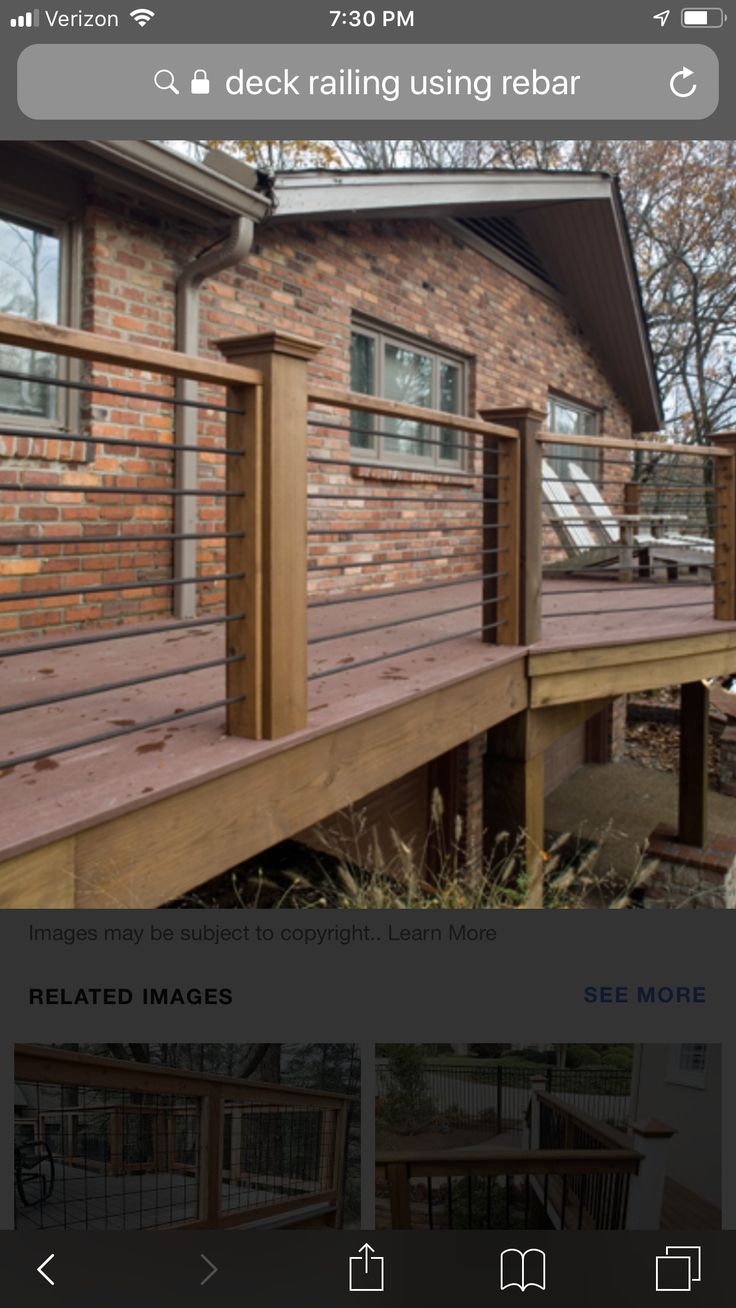 an image of a wooden deck with railings on the front and side of it