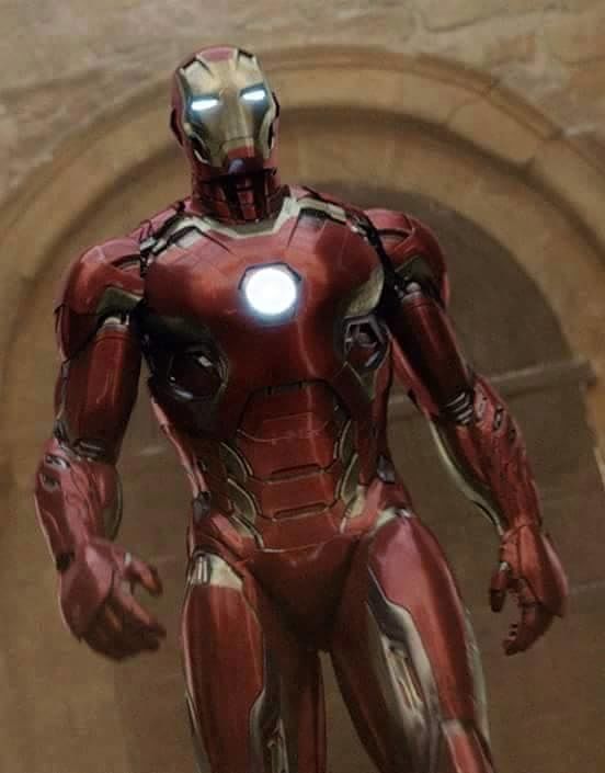 the iron man is standing in front of a stone wall with arched doorways and windows