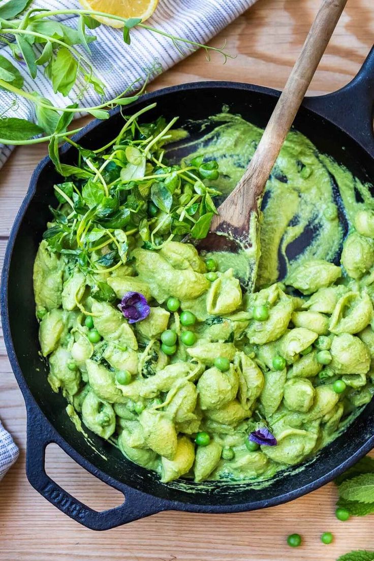 a skillet filled with guacamole and garnished with fresh herbs