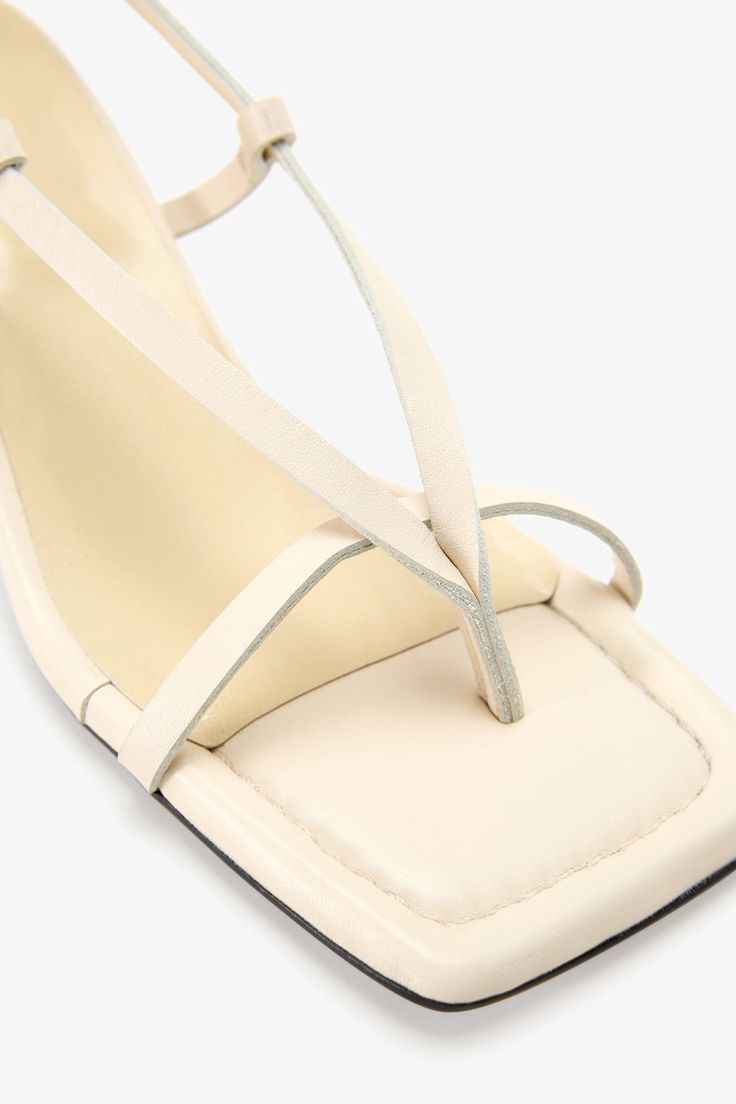 Strappy sophistication. Our Greta Sandals feature a modern square toe and an adjustable slingback strap for a flattering look, enhanced by a chic kitten heel and minimalist raw edges. Whether it's running between meetings or dancing the night away, their padded soles and soft Italian leather let you do it all in comfort—and impeccable style.[SPLIT] Astrid wears Greta in cream, in disco, and in black. Heel height is approximately 2" (5 cm). Sold in US sizes, though please note that shoes may be l Summer Cream Kitten Heels With Ankle Strap, Cream Ankle Strap Kitten Heels For Summer, Summer Cream Leather Kitten Heels, Modern Summer Kitten Heels With Low Heel, Modern Kitten Heels With Low Heel For Summer, Modern Kitten Heels For Summer, Cream Kitten Heels For Summer, Spring Square Toe Slingback Sandals With Heel Strap, Summer Cream Kitten Heels With Heel Strap