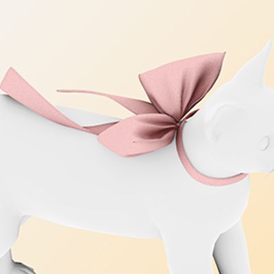 a white cat with a pink bow on it's head is standing in front of a beige background