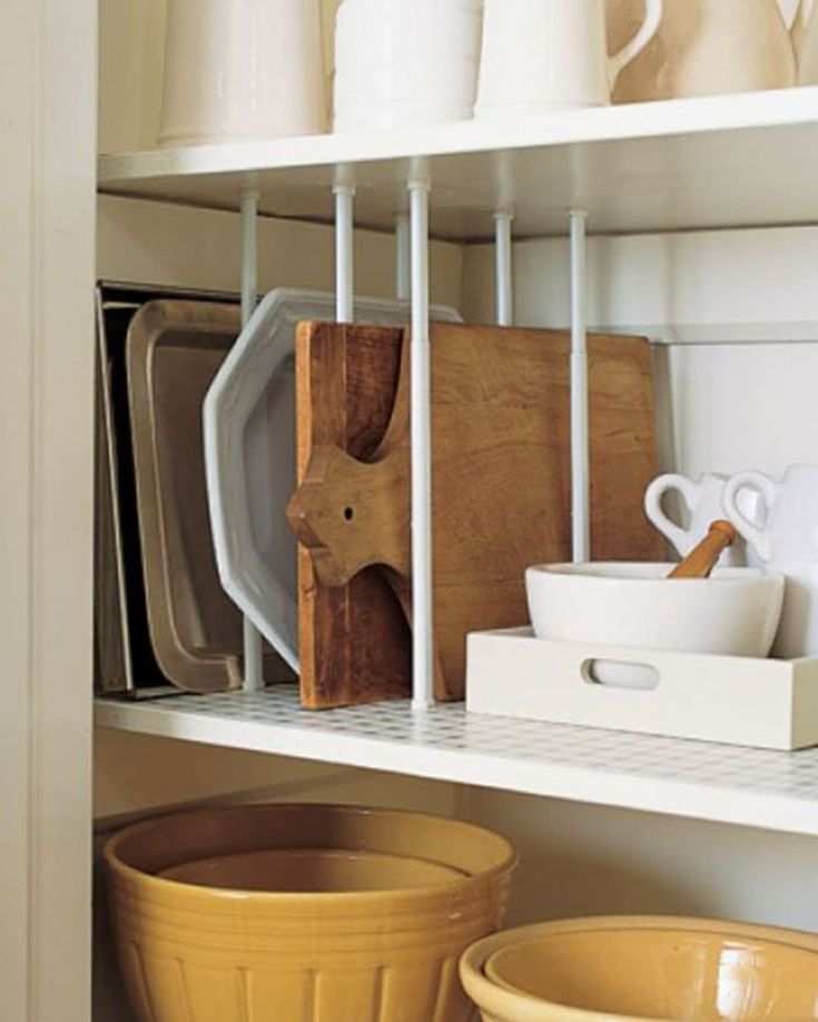 the shelves are filled with dishes and bowls