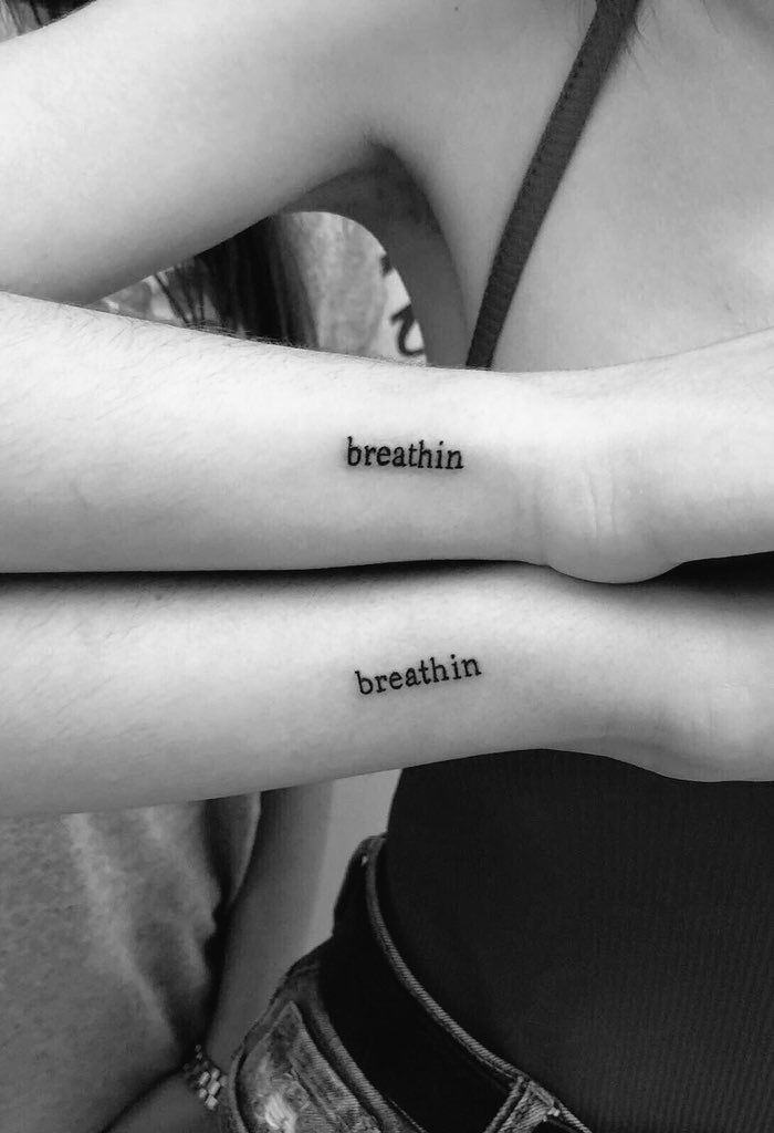 two people with tattoos on their arms and the words breathe, breakin'in